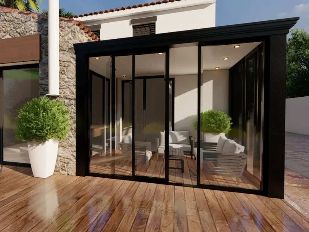 Véranda aluminium noire sur une terrasse en bois